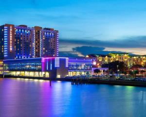 a lit up building next to a body of water at Coastal Escape: Sleek King Suite on Half Acre in Gulfport