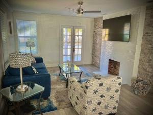 a living room with a couch and a table at Coastal Escape: Sleek King Suite on Half Acre in Gulfport