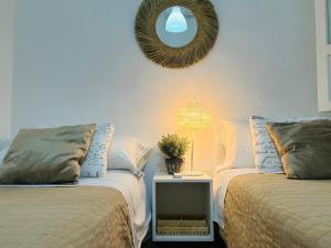 two beds in a room with a mirror on the wall at Clemens9 Premium in Málaga