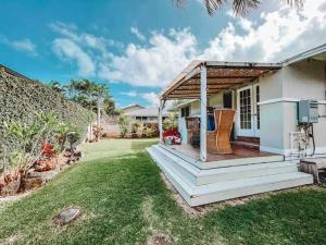 a house with a porch with a wooden deck at ____Cute Plantation House in Kailua with AC!!_____ in Kailua