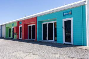 a row of brightly colored buildings on a street at Port Lincoln Shark Apartment 4 in Port Lincoln