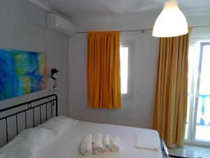 a bedroom with a bed with two towels on it at Sunloft-Paros in Naousa