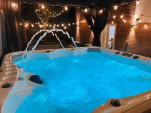 a hot tub in a room with lights at Numero Uno Detached Aparthouse in Newcastle upon Tyne