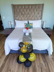 a bed with a bunch of balloons on it at Ekuthuleni Modern Christian Guesthouse with seaview in Umhlanga Ridge