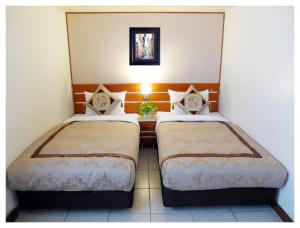 Postel nebo postele na pokoji v ubytování Hua Guo Hotel