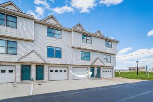 a large white building with two garages at OCTIPI Your SenSEAS in Kitty Hawk