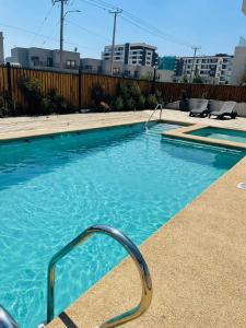 a swimming pool with a hand rail in the water at Inmobiliaria Avellano in Los Ángeles