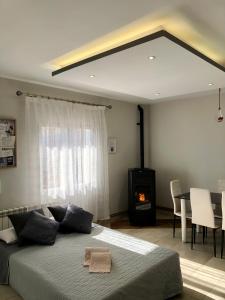 a bedroom with a bed and a fireplace and a table at Casa La Mimbrera in Las Navas del Marqués