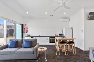 a living room with a couch and a table at Port Lincoln Shark Apartment 5 in Port Lincoln