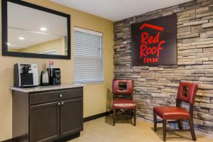 um bar com duas cadeiras e uma placa de pousada com telhado vermelho em Red Roof Inn Hershey em Hershey