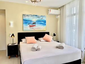 1 dormitorio con 1 cama y una pintura de un barco en Beach Apartment, Rua Navegantes - Boa Viagem, en Recife