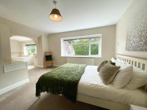 a bedroom with a large bed and a window at Big House in countryside near Cardiff in Rudry