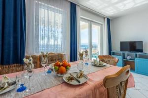 a dining room with a table with fruit on it at Apartments Bozana in Dramalj