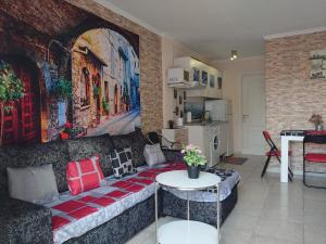 a living room with a couch and a painting on the wall at Las Floritas in Playa de las Americas