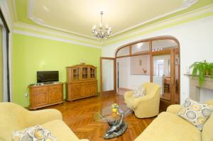 a living room with two chairs and a television at Apartments Romina in Rijeka