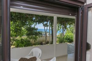 a sliding glass door with a view of the ocean at Apartments Aleksandar in Ulcinj