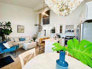 a kitchen and living room with a table and chairs at Gulf Front Penthouse Condo in Pensacola Beach