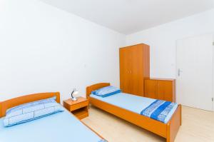Posteľ alebo postele v izbe v ubytovaní Apartments Kazimir