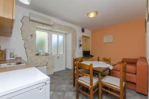 a kitchen and dining room with a table and chairs at Apartments Anita in Slatine