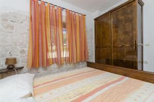 a bedroom with a bed and a large window at Apartments Anita in Slatine