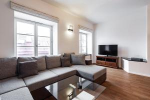 a living room with a couch and a flat screen tv at AirHome - Raekoja Plats in Tallinn