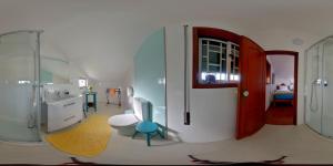 a bathroom with a sink and a toilet and a shower at A Casa da Ti Laura - AL in Aveiro +73 photos