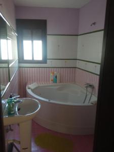 a bathroom with a large tub and a sink at El Corchuelo in Corteconcepción +22 photos
