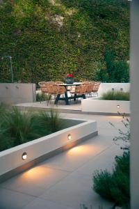 a patio with a table and chairs and lights at Araliki in Polychrono