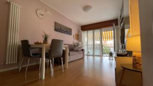 a living room with a table and a couch at Civico 32 in Montalto Dora