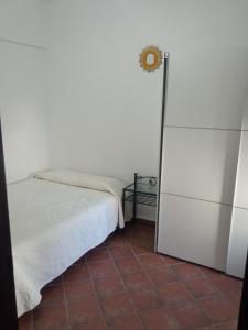 a small bedroom with a bed and a refrigerator at El Corchuelo in Corteconcepción