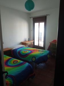 a bedroom with two beds and a window at El Corchuelo in Corteconcepción