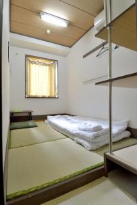 Säng eller sängar i ett rum på Juyoh Hotel