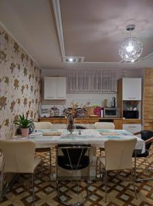 a kitchen with a table and chairs in a room at Ubytovňa Ivona in Hroboňovo