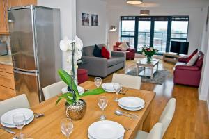 BOOK A BASE Apartments - Duke Street في ليفربول: غرفة طعام وغرفة معيشة مع طاولة وكراسي