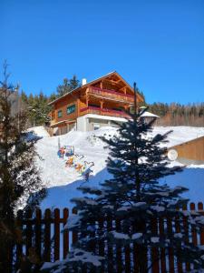 a ski lodge with a christmas tree in the snow at Wald-Panorama-Zimmer in Mönichkirchen
