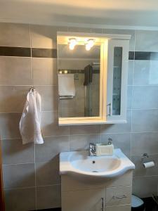 a bathroom with a sink and a mirror at Villa Delfini in Chrani +62 photos