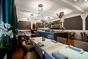 a restaurant with tables and chairs and a bar at Hotel Jacobs in Bruges +37 photos