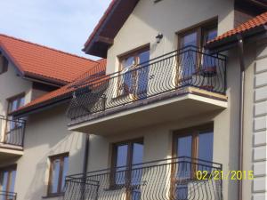 a building with balconies on the side of it at Apartamenty by Hanna in Łeba