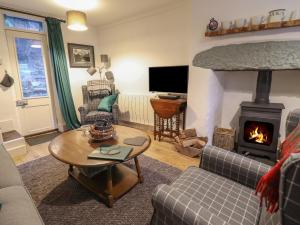 a living room with a couch and a fireplace at 1 Llwyn Hir in Blaenau-Ffestiniog