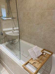 a bath tub with a tray in a bathroom at Stunning Marina apartment Gosport Portsmouth in Gosport