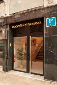 a store front of a building with a sign on it at Bilbao ROOMS & KITCHEN Zorroza in Bilbao