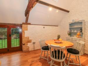 a kitchen with a wooden table and chairs at The Old Granary in Beaminster
