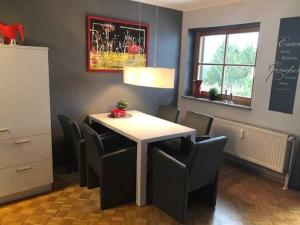 une salle à manger avec une table et des chaises blanches dans l'établissement MountainLodge, à Altenau