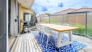a wooden deck with a table and chairs on a balcony at Sandpiper 9 - Close to Town and Beach in Inverloch