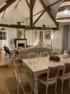 a living room with a table and a couch at La Courmonière in Courmont