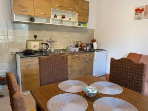 a kitchen with a table with plates on it at Guest House Kevser in Sarajevo