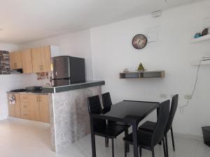 a kitchen with a table and chairs and a refrigerator at MALALA3 depa amoblado in Sincelejo