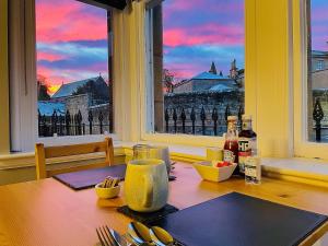 a dining room table with a view of a city at Shandwick House in Tain