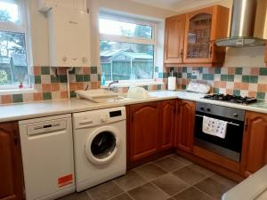 a kitchen with a washing machine and a sink at Kara Mia in Boston