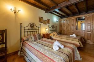 una camera da letto con due letti con asciugamani sopra di Casa vacacional Dario a Rales